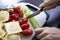 Woman\'s hand chopping cucumber at kitchen counter