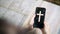 Woman`s hand with cross in screen mobile phone. Concept of hope, faith, christianity, religion, church online