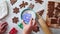 A woman`s hand dips a cookie cutter into a bowl of flour, leaving a snowflake pattern on the surface. Top view, close-up. The conc