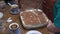 A woman\\\'s hand divides the newly cooked cake into pieces. She presents a sweet dessert with tea