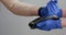 Woman`s hand in gloves using smartwatch to purchase product at the point of sale terminal in a retail store with nfc