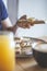 Woman`s hand grabbing a peanut butter, banana and strawberry toast on a table with fresh juice and coffee