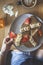 Woman`s hand grabbing a peanut butter, banana and strawberry toast on a table with fresh juice and coffee