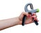 Woman`s hand with hand expander hand gripper. Hand grip strengthening tool. Expander with spring.