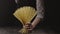 Woman\'s hand hold uncooked spaghetti as a bouquet on a dark background. Slow motion, Full HD video, 240fps, 1080p.