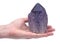Woman`s hand holding Ametrine lightbrary point from Bolivia