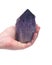 Woman`s hand holding Ametrine lightbrary point from Bolivia