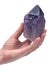 Woman`s hand holding Ametrine lightbrary point from Bolivia