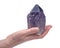Woman`s hand holding Ametrine lightbrary point from Bolivia