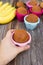 Woman\'s hand holding banana cake in colorful baking pan.