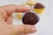 Woman`s hand holding Brazilian candy Brigadeiro brigadier candy. Chocolate dessert.