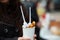 Woman`s hand holding bubble waffle in a paper cup with plastic spoon