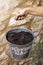 Woman\\\'s hand holding bucket of gardening soil. Elements of domestic gardening. Hard work concept