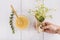 woman s hand holding bunch chamomile flowers near bowl lemon curd. High quality photo