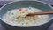 Woman`s hand holding chopstick for eating instant noodles in bowl, it is designed to be cooked or soaked in boiling water before e