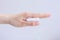 Woman`s hand holding clean cotton tampon close-up. Young woman preparing menstruation time. Soft tender protection woman