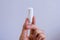 Woman`s hand holding clean cotton tampon close-up. Young woman preparing menstruation time. Soft tender protection woman