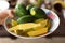 Woman`s Hand Holding Cut Green Mangos in a Bowl