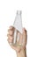 Woman`s hand holding empty glass bottle transparent on white background