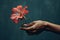 Woman\\\'s hand holding a flower minimalist concept