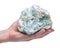 Woman`s hand holding Green Apophyllite Cluster in matrix