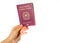 Woman`s hand holding an Italian passport isolated