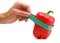 Woman\'s hand holding measuring tape with paprika.