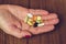 Woman`s hand holding the mix of vitamins and nutritional, dietary supplement pills, close-up.