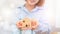 Woman`s hand holding a model wooden house