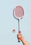 Woman`s hand holding a retro badminton racket