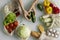 Woman`s hand, holding a reusable grocery bag with vegetables on a kitchen at home and takes cucumber out. Zero waste and