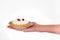 Woman`s hand holding small dessert cake on delicate set plate