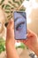 Woman& x27;s hand holding smartphone device with macro eyelash extensions picture