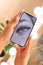 Woman& x27;s hand holding smartphone device with macro eyelash extensions picture