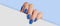Woman\\\'s hand holding white paper. Fashionable blue nail design