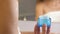 Woman's hand holds an anti-aging moisturizer in a blue glass jar. Reflection in the mirror. Skin care cosmetic product.