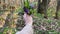 A woman\\\'s hand holds a bouquet of the first spring forest flowers in the forest