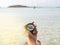 A woman`s hand holds a compass on the beach