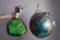 A woman`s hand holds a garbage bag next to the globe of planet Earth. Concept of ecology and environmental protection. The recycl