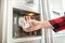 Woman`s hand holds glass and uses refrigerator