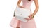 Woman\'s hand holds white bag.