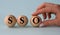 A woman\'s hand holds a wooden ball with the abbreviation SSO