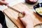 Woman`s hand with a knife cutting the boiling potatoes