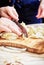 Woman`s hand with a knife cutting the boiling potatoes