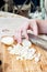 Woman`s hand with a knife cutting the boiling potatoes