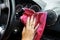 Woman\'s hand with microfiber cloth polishing of a car