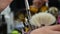 A woman`s hand picks up a small makeup brush from the table in a beauty salon,