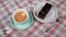 A woman`s hand places a cup of coffee on a table.