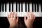 Woman\'s hand playing piano.