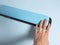 A woman`s hand presses the button of a blue vacuum packer. the concept of preserving products